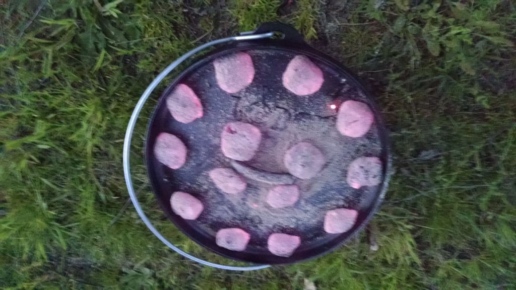 coals on top of dutch oven for Empty Dutch Oven for strawberry cobbler via dutch oven