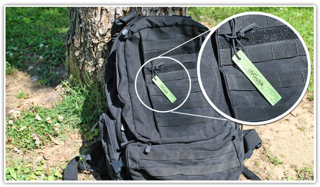 A UV Glostik on a book bag as a zipper pull for nighttime marking